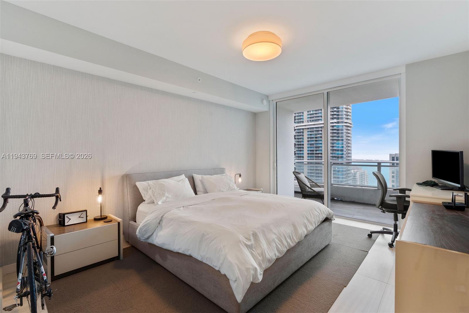 1080 Brickell Avenue, Unit 3702 Miami, FL 33131 - Photo 14 of 24 a bedroom with a bed and a couch