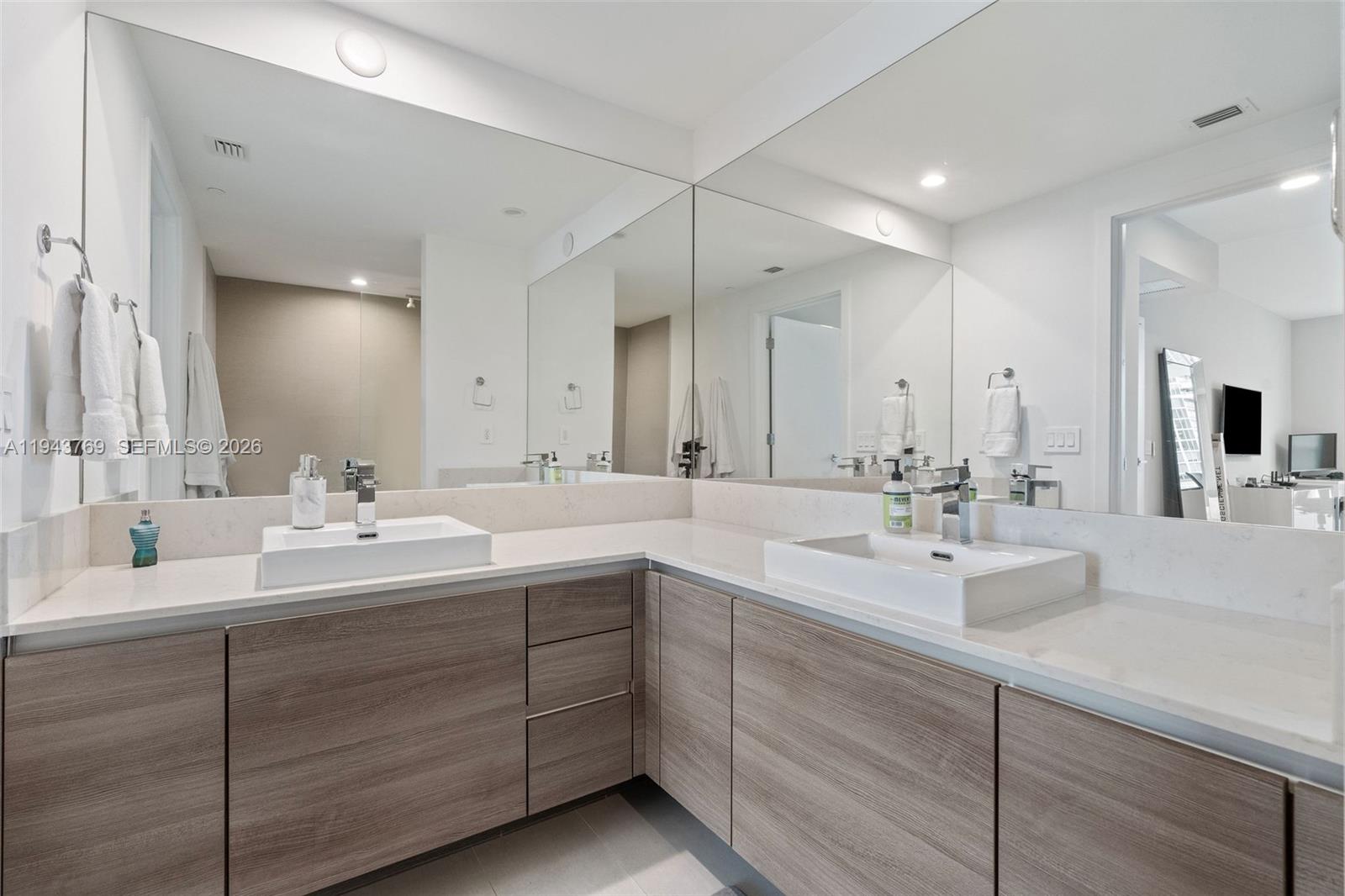 1080 Brickell Avenue, Unit 3702 Miami, FL 33131 - Photo 17 of 24 a bathroom with double vanity sinks and a mirror