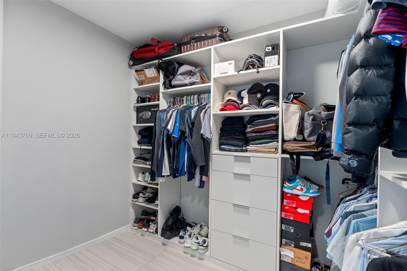 1080 Brickell Avenue, Unit 3702 Miami, FL 33131 - Photo 18 of 24 a view of walk in closet with clothes and shoes