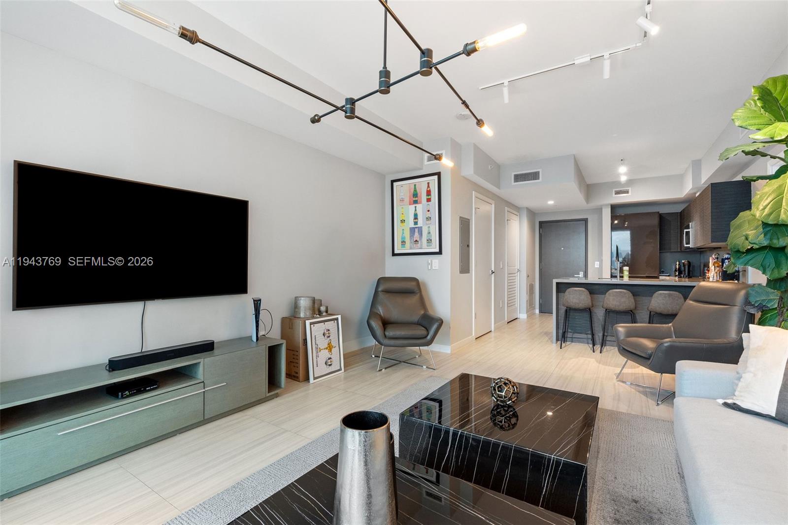 1080 Brickell Avenue, Unit 3702 Miami, FL 33131 - Photo 8 of 24 a living room with furniture and a flat screen tv