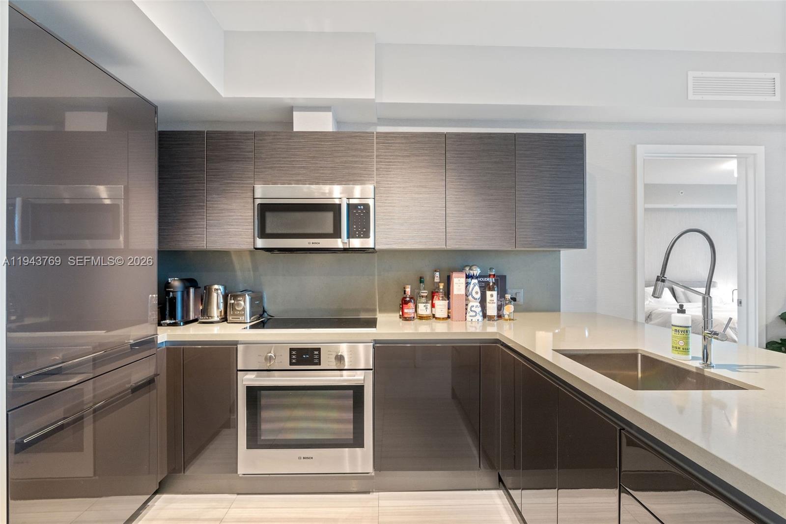 1080 Brickell Avenue, Unit 3702 Miami, FL 33131 - Photo 10 of 24 a kitchen with a sink cabinets and stainless steel appliances