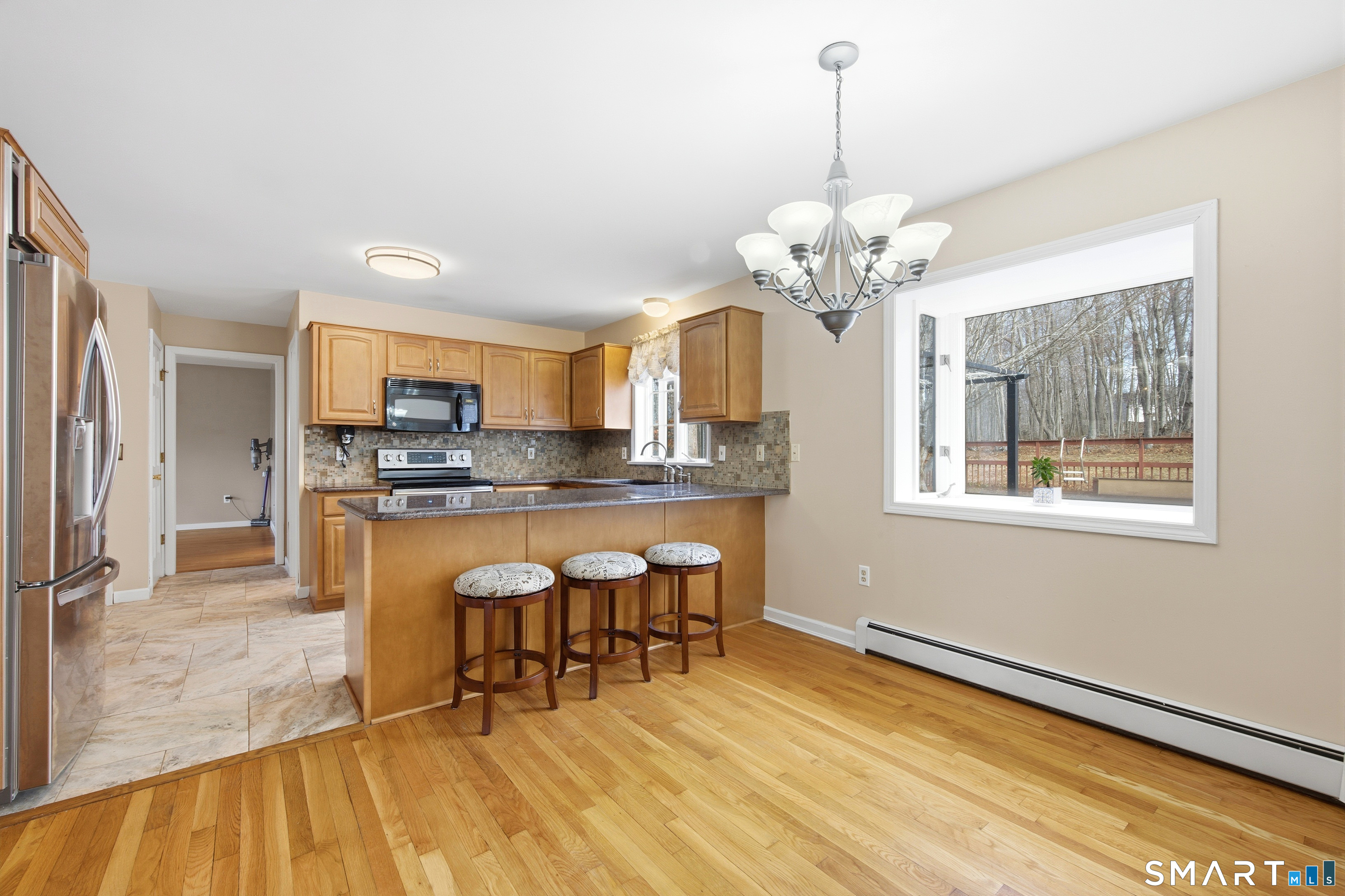 48 Bittersweet Drive Ledyard, CT 06335 - Photo 1 of 1 a dining room filled chandelier and wooden floor