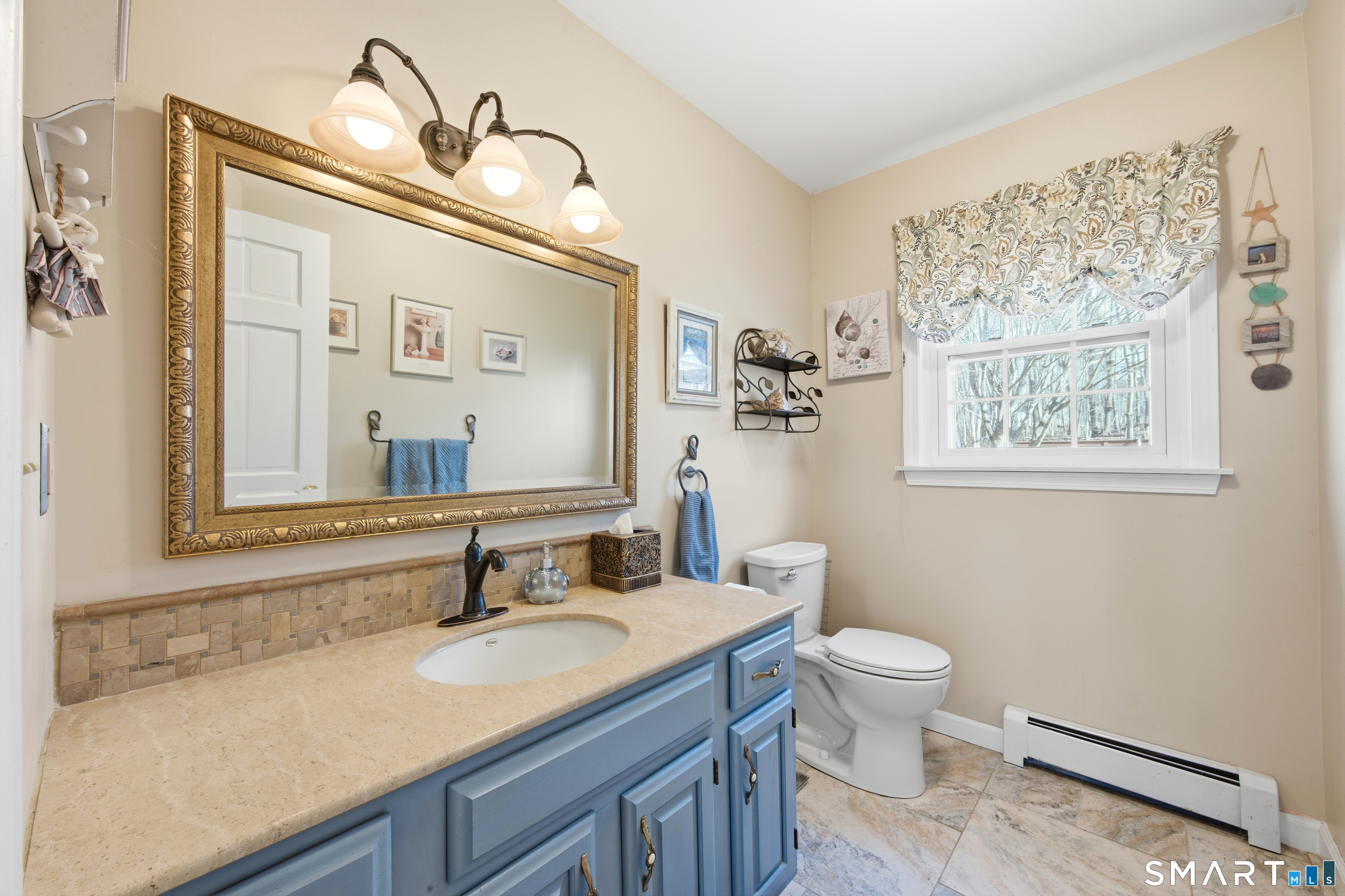 48 Bittersweet Drive Ledyard, CT 06335 - Photo 27 of 38 a bathroom with a granite countertop sink mirror vanity and toilet