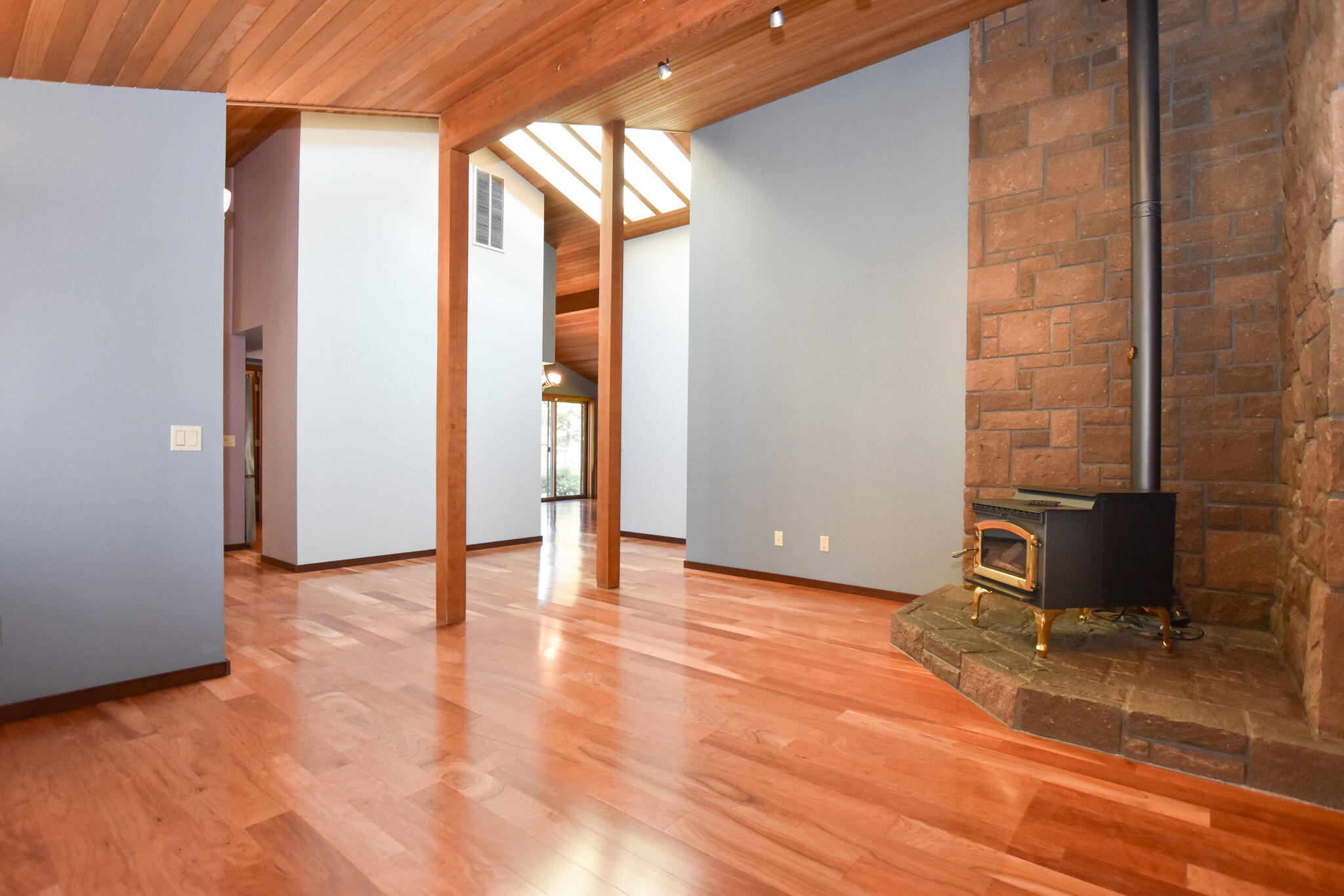 64730 Sylvan Loop Bend, OR 97701 - Photo 16 of 46 a view of an empty room with wooden floor and a window