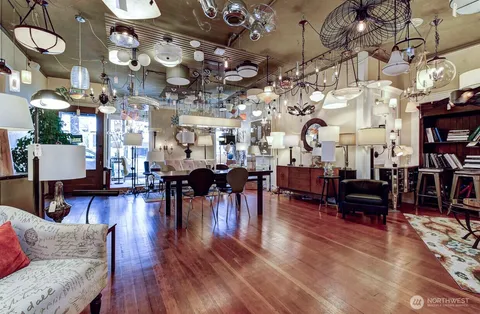 a living room filled with furniture and a chandelier