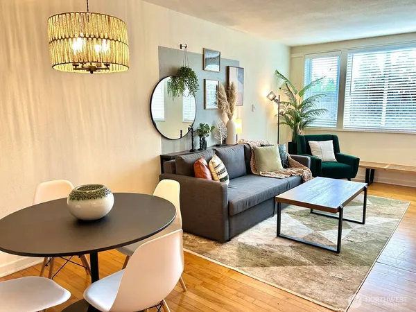 a living room with furniture a table and a chandelier