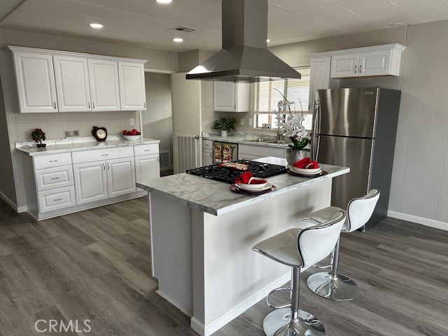 881 North Lake Street, Unit 204 Hemet, CA 92544 - Photo 4 of 10 a kitchen with stainless steel appliances granite countertop a refrigerator a sink dishwasher a stove and white cabinets with wooden floor