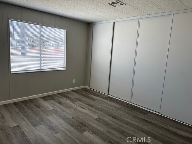 881 North Lake Street, Unit 204 Hemet, CA 92544 - Photo 7 of 10 a view of an empty room with wooden floor and a window