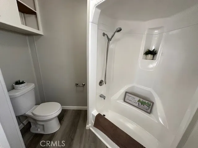 a bathroom with a toilet and a shower