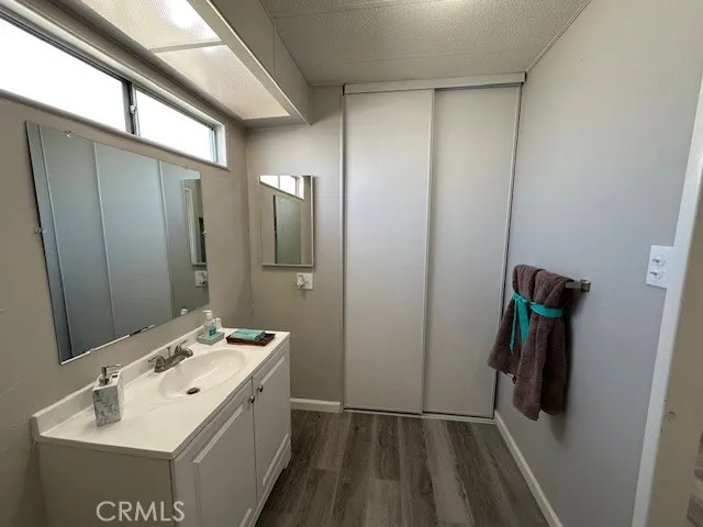 a bathroom with a sink a toilet and mirror