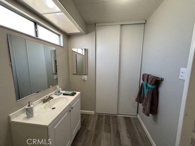 881 North Lake Street, Unit 204 Hemet, CA 92544 - Photo 10 of 10 a bathroom with a sink a toilet and mirror