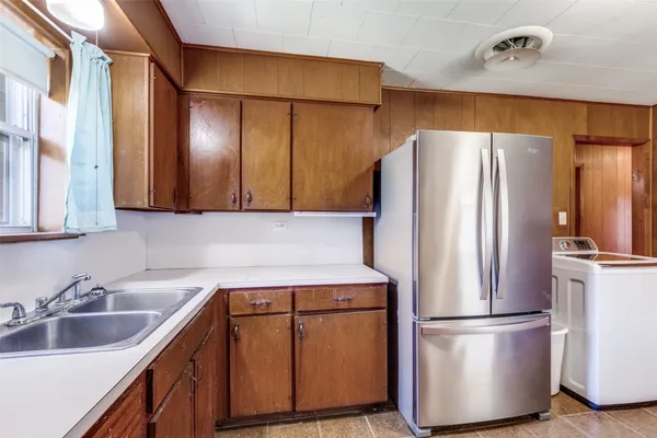 a kitchen with stainless steel appliances a refrigerator and a sink