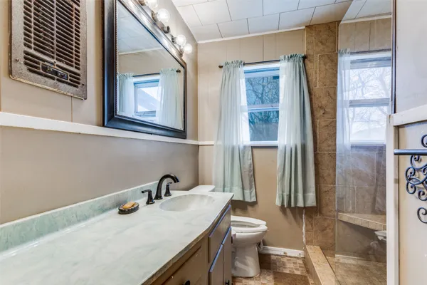 a bathroom with a sink toilet and shower