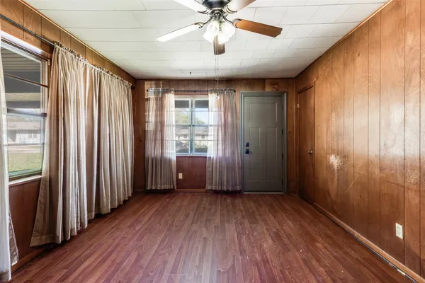 wooden floor in an empty room with a window