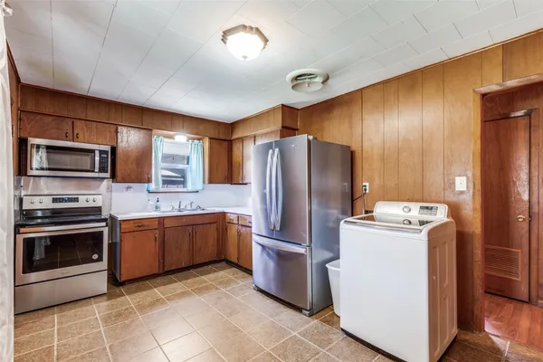 a kitchen with stainless steel appliances granite countertop a refrigerator stove and oven