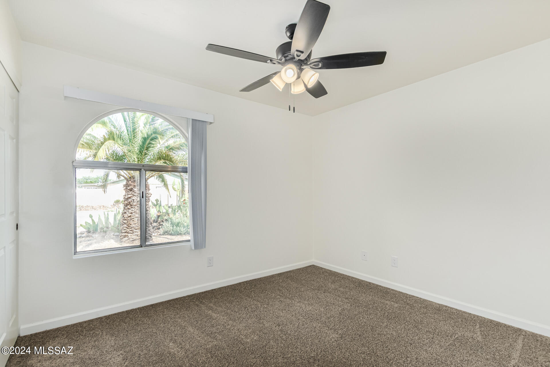 1454 South Gecko Road Tucson, AZ 85713 - Photo 14 of 24 an empty room with a window and a fan