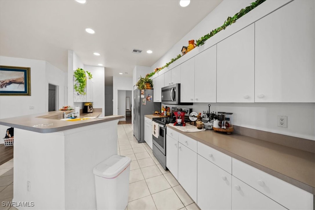 20025 Lake Vista Circle, Unit 6B LaBelle, FL 33935 - Photo 13 of 36 a kitchen with sink cabinets and window