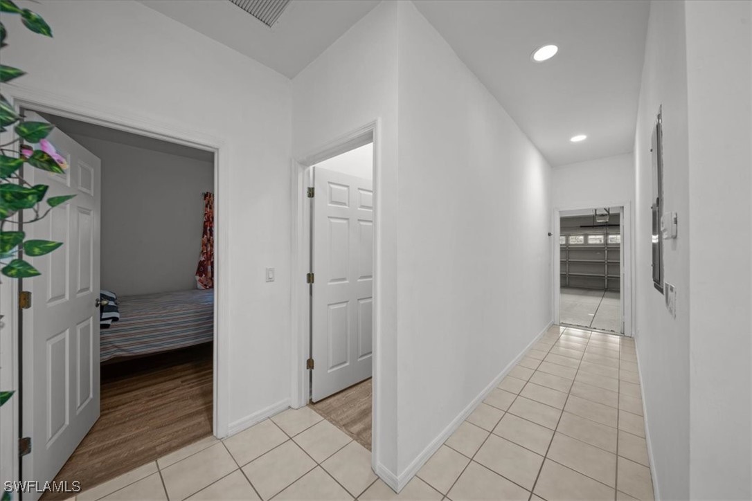 20025 Lake Vista Circle, Unit 6B LaBelle, FL 33935 - Photo 17 of 36 a view of hallway with walk in closet and wooden floor
