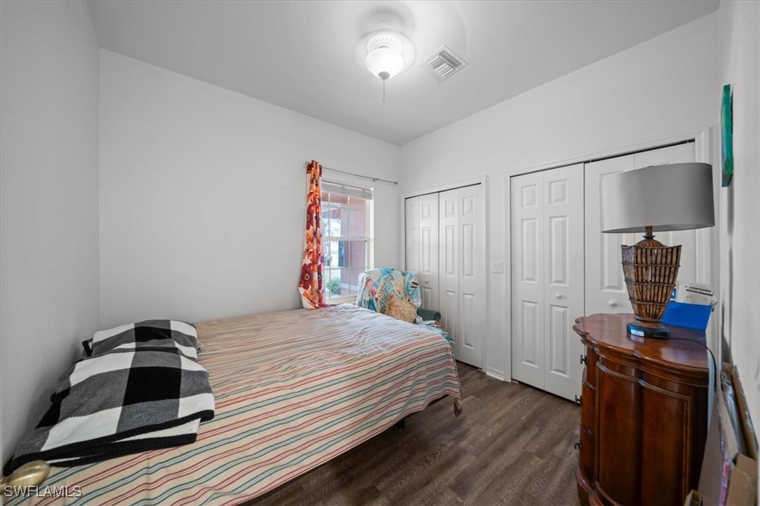 20025 Lake Vista Circle, Unit 6B LaBelle, FL 33935 - Photo 19 of 36 a bedroom with a bed and a wooden floor