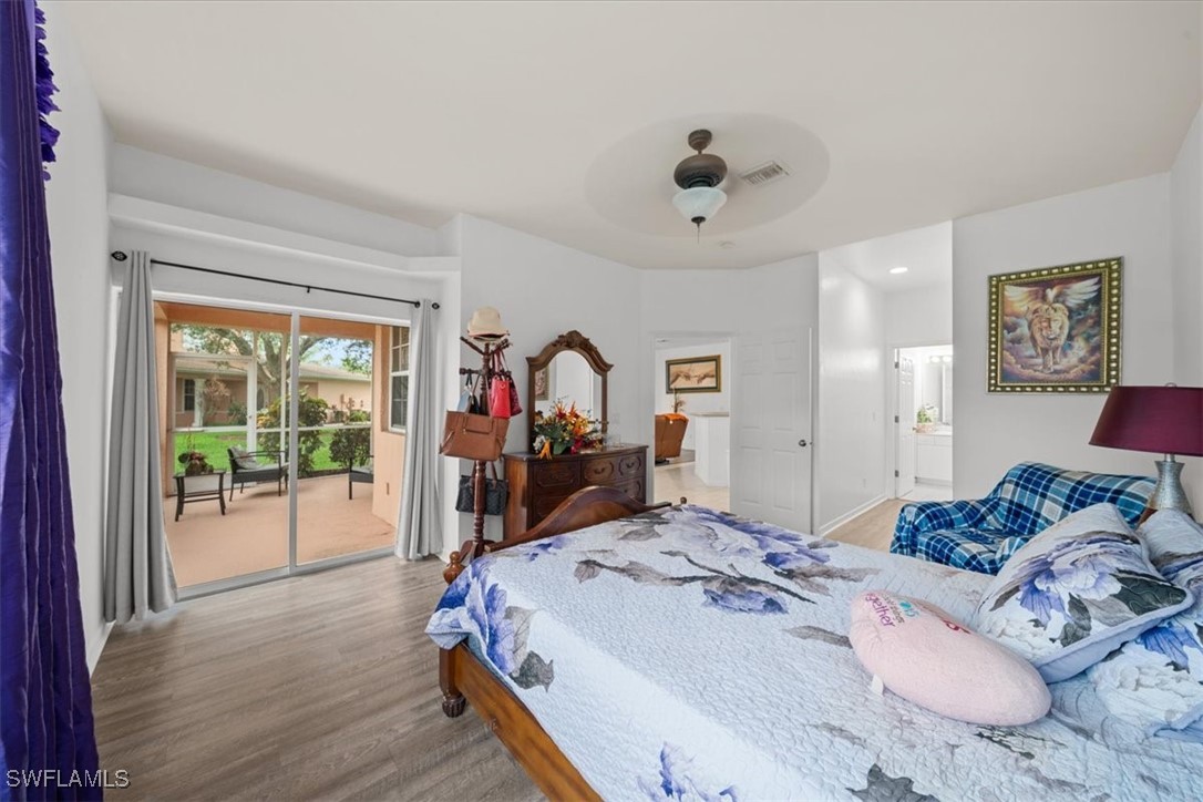 20025 Lake Vista Circle, Unit 6B LaBelle, FL 33935 - Photo 24 of 36 a bed room with a bed and a large mirror