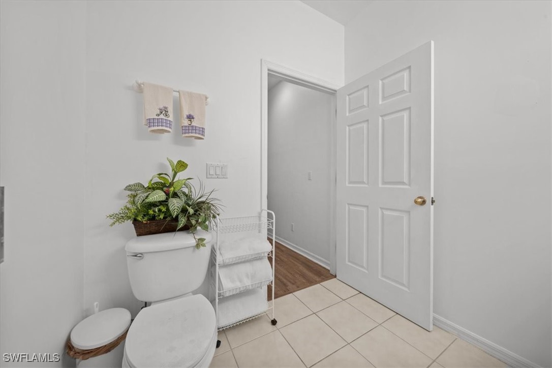 20025 Lake Vista Circle, Unit 6B LaBelle, FL 33935 - Photo 26 of 36 a white toilet sitting next to a bathroom sink