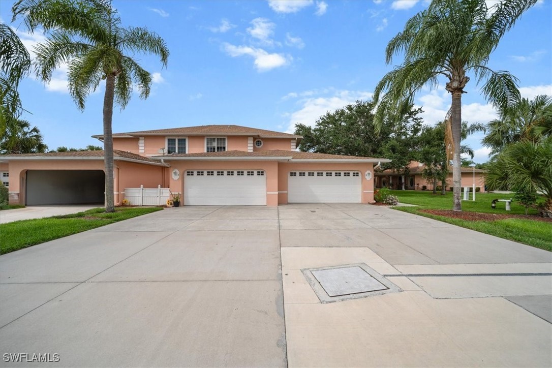 20025 Lake Vista Circle, Unit 6B LaBelle, FL 33935 - Photo 4 of 36 a view of a house with a yard and palm trees