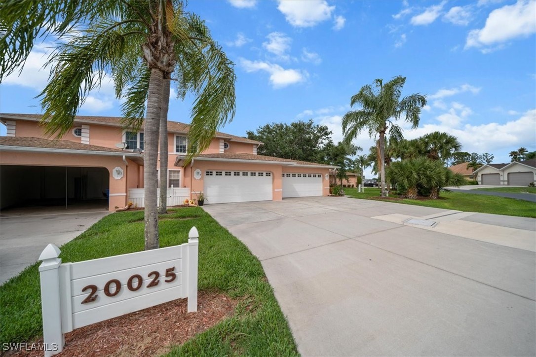 20025 Lake Vista Circle, Unit 6B LaBelle, FL 33935 - Photo 5 of 36 a view of a street with potted plants and palm trees