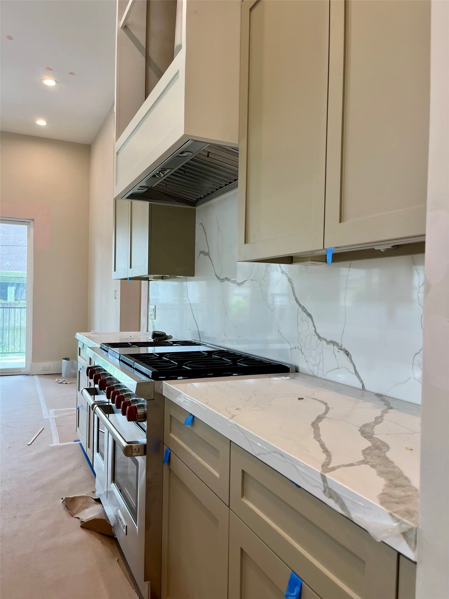 4623 Verone Street Bellaire, TX 77401 - Photo 6 of 8 a kitchen with granite countertop a sink a stove and a microwave