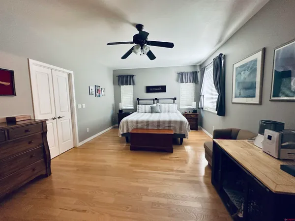 a spacious bedroom with a bed and a dresser