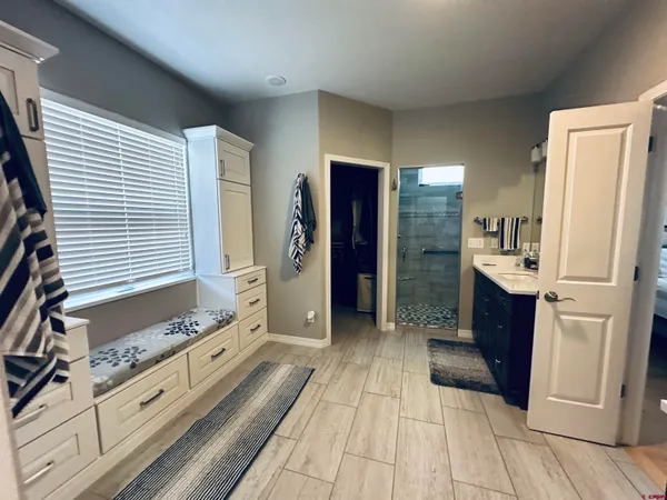 a large bathroom with a double vanity sink a large mirror and a shower