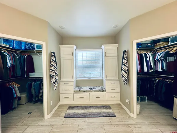 a view of a hallway with wooden shelves