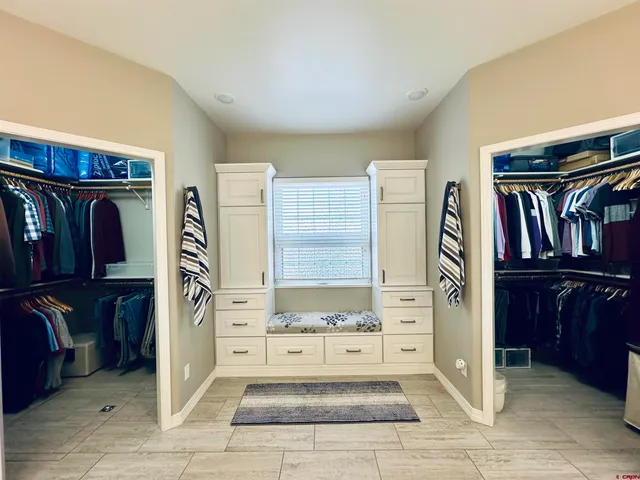 a view of a hallway with wooden shelves