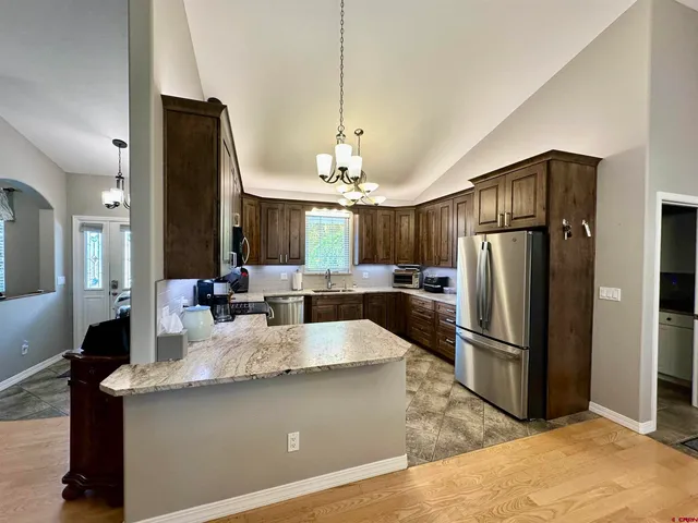 a large kitchen with a refrigerator a sink and a stove