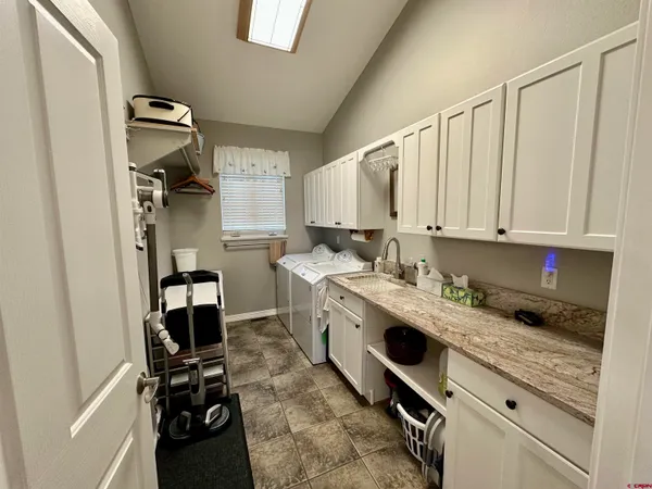 a kitchen with a sink cabinets and appliances