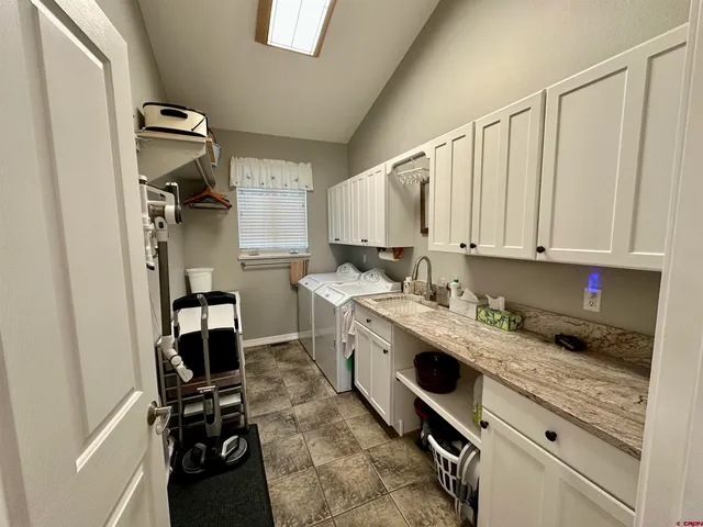 a kitchen with a sink cabinets and appliances