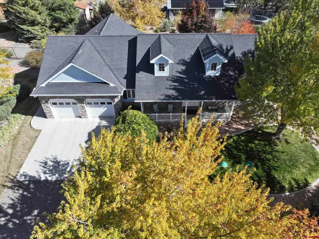 an aerial view of a house with a yard and garden
