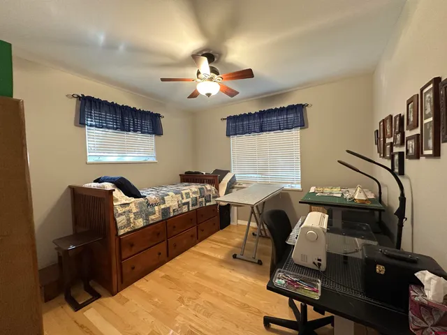 a livingroom with workspace couch and a window