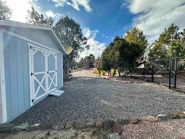 a view of a yard with a tree
