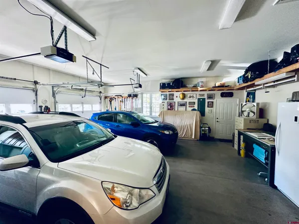 a living room with lots of furniture and a fan