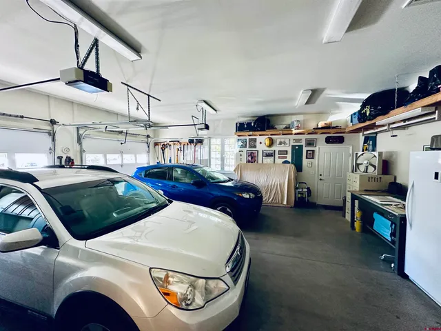 a living room with lots of furniture and a fan