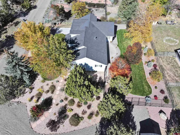 an aerial view of a house with a yard and garden