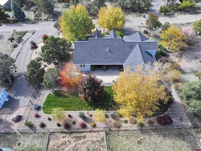 a view of a house with a yard and garden