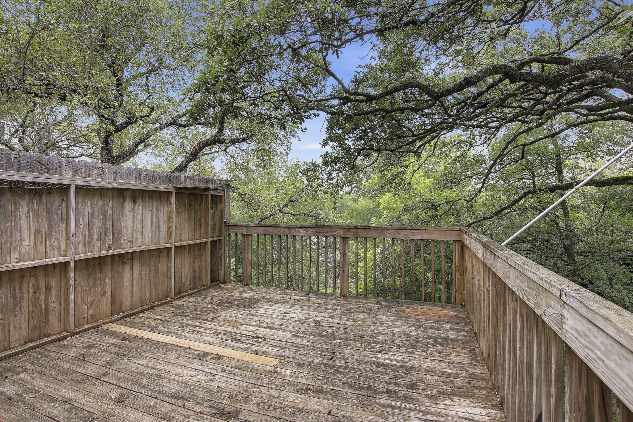 6902 Rifle Bend Austin, TX 78736 - Photo 30 of 33 a balcony with wooden floor and wooden fence