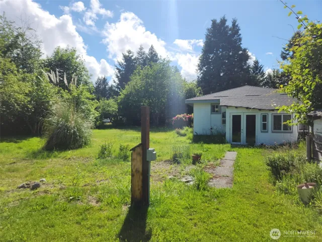 a view of a house with a yard and a garden