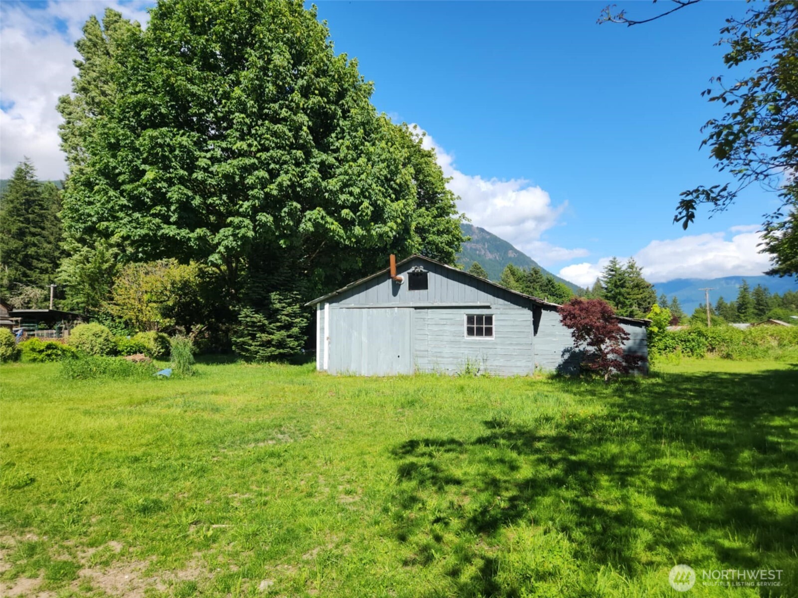 160 Gharet Road Randle, WA 98377 - Photo 23 of 26 a house with green field in front of it