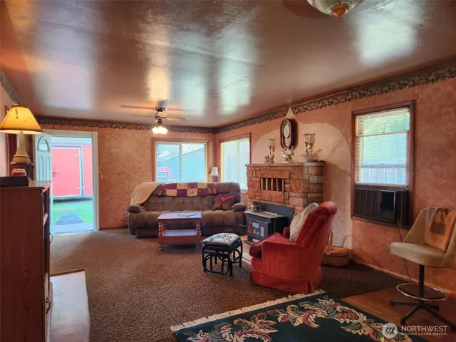 a living room with furniture a fireplace and a chandelier