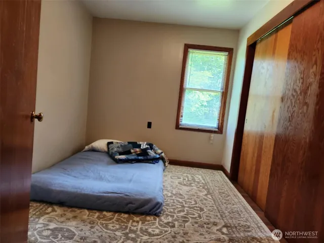 a bedroom with a bed and a window
