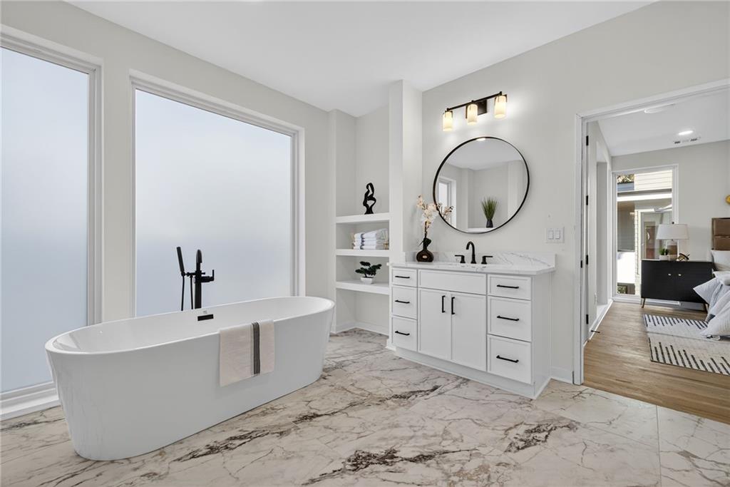 163 Walthall Street Southeast, Unit B Atlanta, GA 30316 - Photo 18 of 37 a bathroom with a bathtub sink and mirror