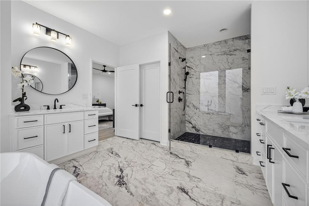 163 Walthall Street Southeast, Unit B Atlanta, GA 30316 - Photo 19 of 37 a spacious bathroom with a mirror a sink and a mirror