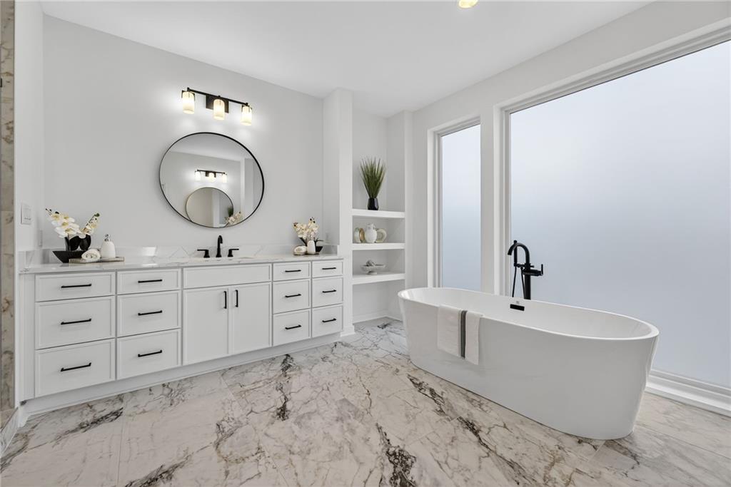 163 Walthall Street Southeast, Unit B Atlanta, GA 30316 - Photo 20 of 37 a spacious bathroom with a double vanity sink mirror and bathtub